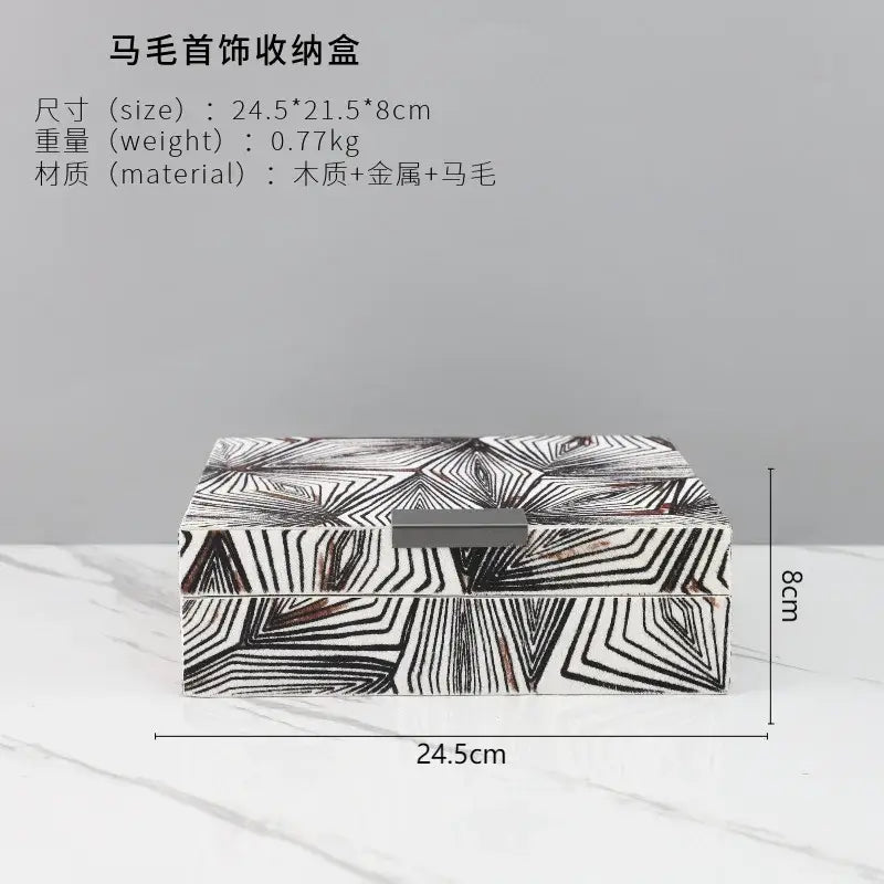 Zebra black and white jewelry storage box with geometric pattern and metallic clasp for desktop organization