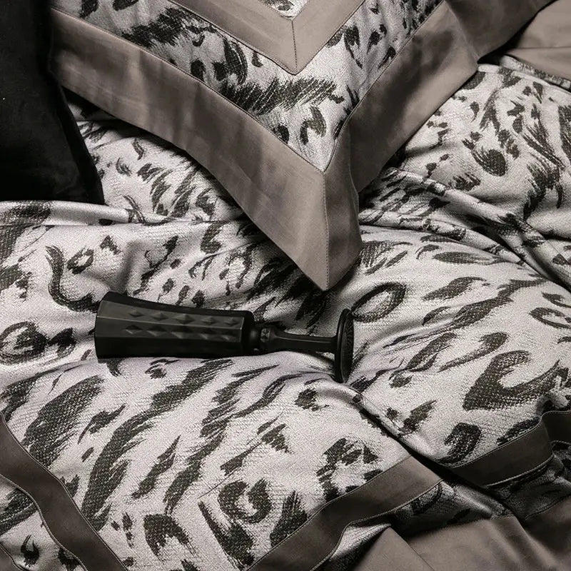 Black textured pump on gray and black patterned bedspread of zebra print decorbites 1000tc egyptian cotton bedding set