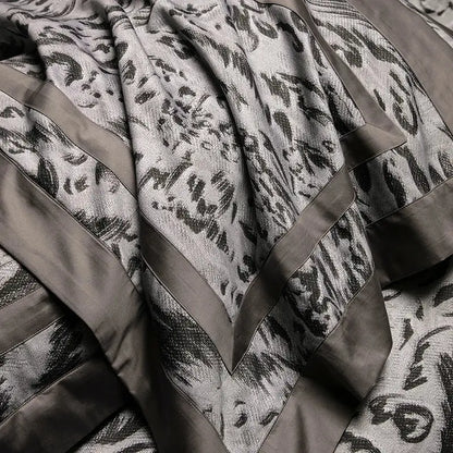 A luxurious gray and black patterned throw blanket with bold abstract floral motifs in decorbites 1000tc egyptian cotton bedding set
