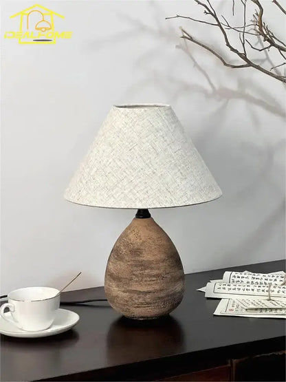 Earthenware teardrop-shaped zen earthy textured ceramic jar led table lamp with natural brown base and beige fabric shade for living room decor