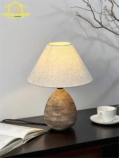 A warm-toned decorbites ceramic jar led table lamp with earthy textured ceramic jar and soft beige linen shade for living room