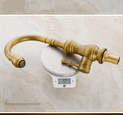 Antique brass kitchen mixer tap with ornate scrollwork single hole deck mounted housing material durable
